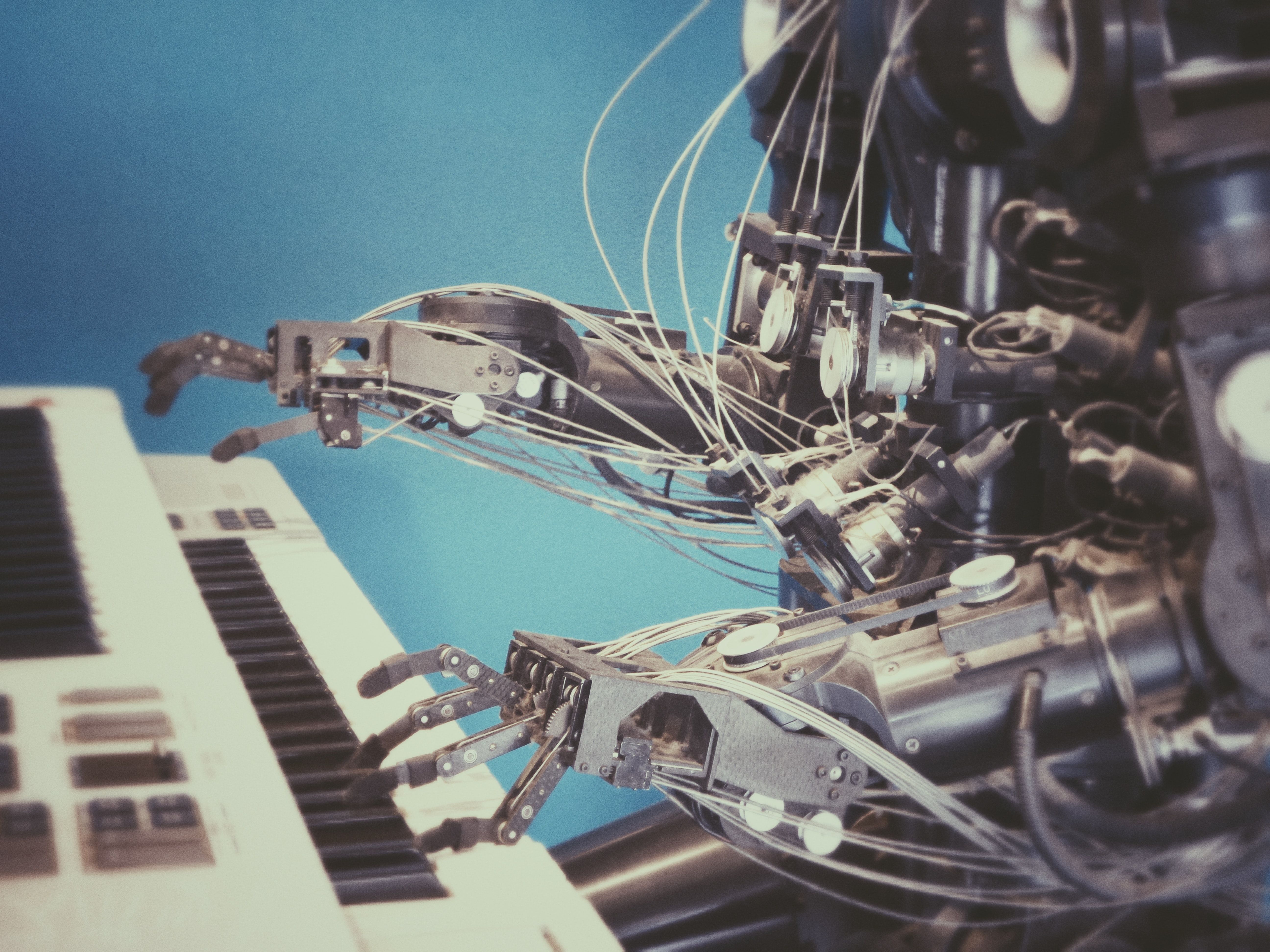 A crude humanoid robot playing synth